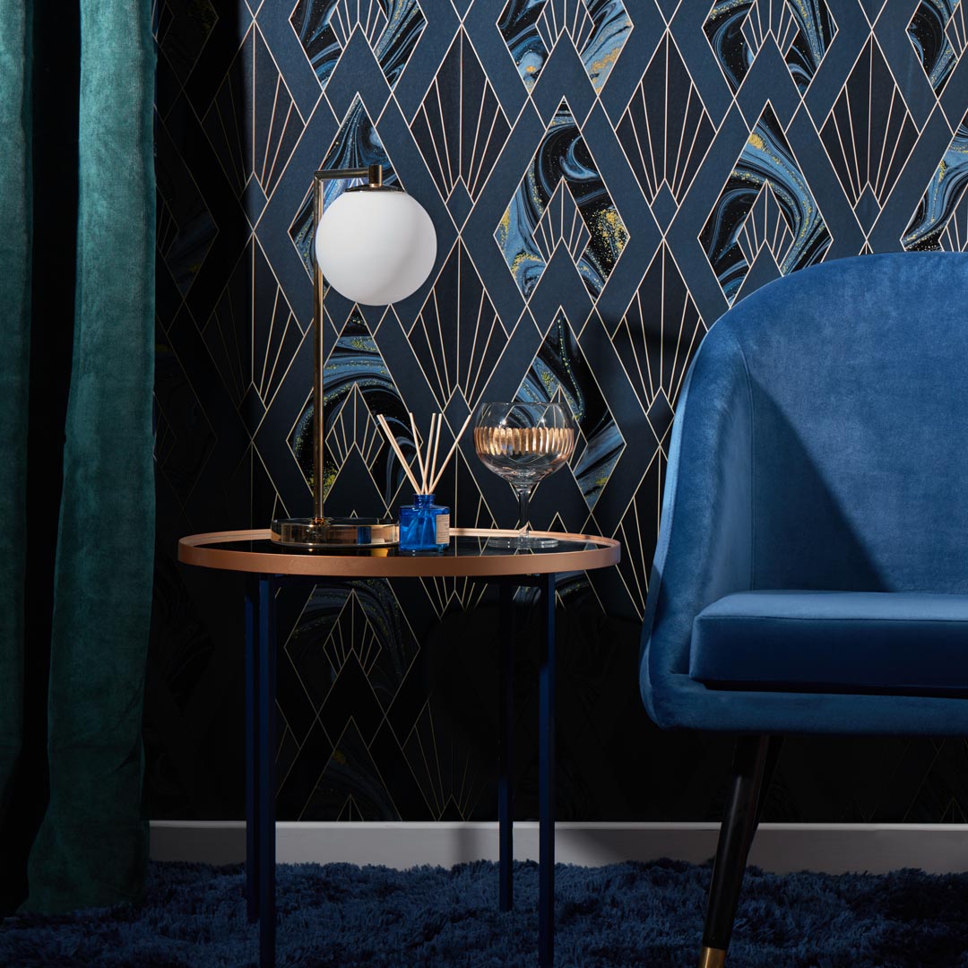 navy blue art deco wallpaper with blue chair and lamp