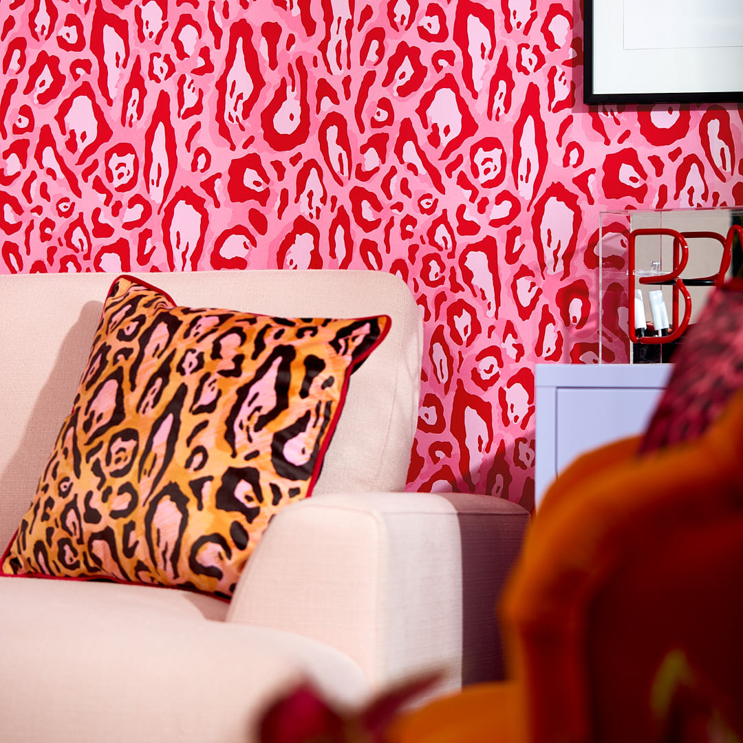 Pink leopard print living room wallpaper with leopard print cushion