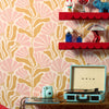 Roomset close-up of matisse pattern wallpaper in ballet pink and deep mustard colourway 